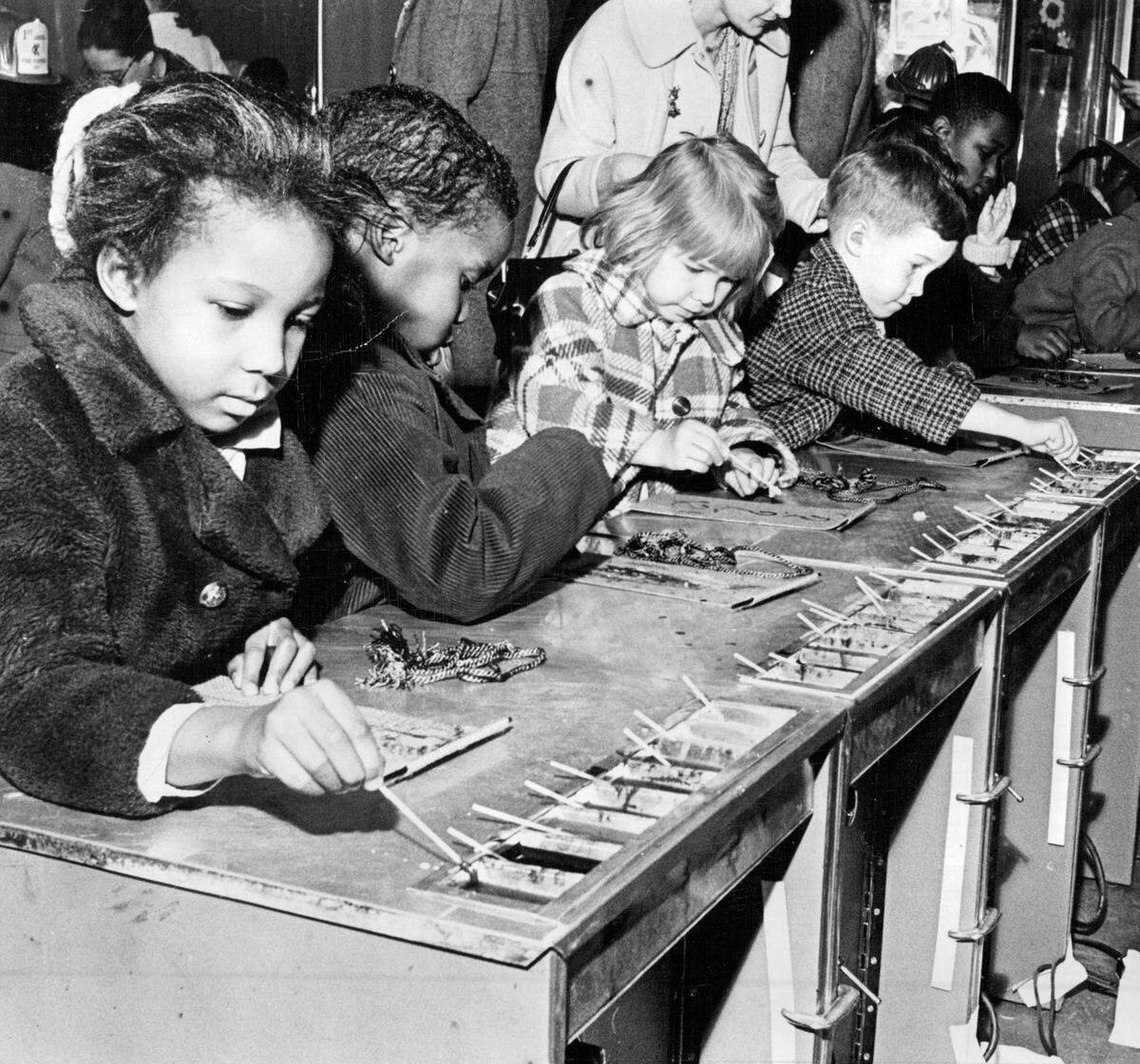 In this 1969 photo, children immerse themselves in a creative experience at Hallmark’s Kaleidoscope exhibit in Municipal Auditorium. Using melted crayon on felt, they explore one of 17 hands-on art activities designed to spark imagination.