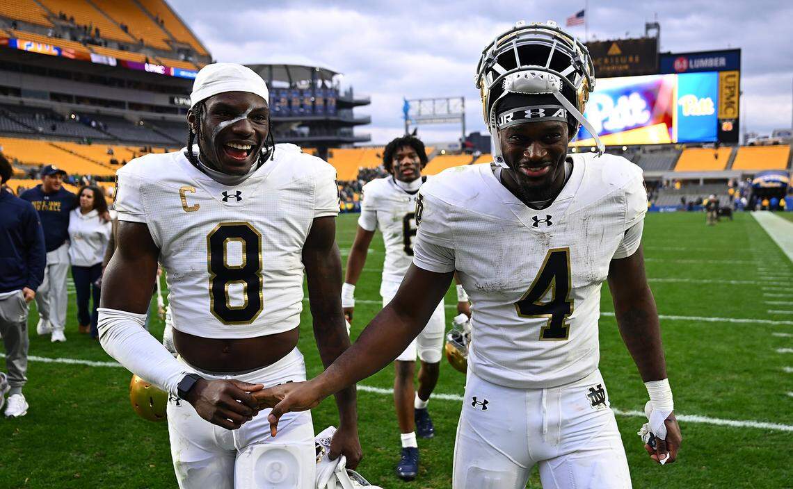 Adon Shuler #8 and Jeremiyah Love #4 of the Notre Dame Fighting Irish celebrate as they walk off the field following a 37-15 win over the Pittsburgh Panthers at Acrisure Stadium on November 15, 2025 in Pittsburgh.
