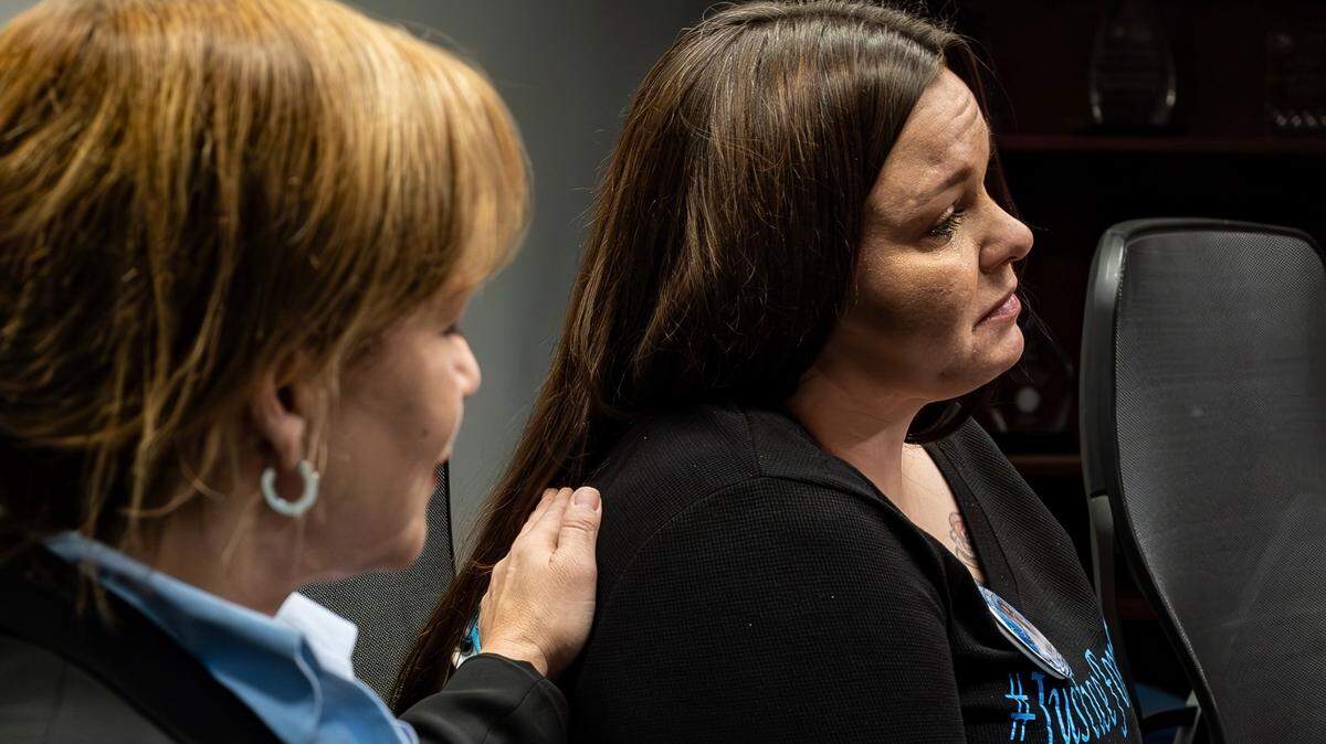Amber O’Connell on Wednesday pleaded for witnesses to come forward with information to help solve the murder of her son, 17-year-old Therrell “TJ” Jackson, last summer. Jackson died after being shot in what investigators believe was a drive-by shooting on July 30 in Avondale, a small city in Kansas City’s Northland. Detective Kristen Rivera with the Clay County Sheriff’s Office places a hand on O’Connell after she teared up talking about her son.