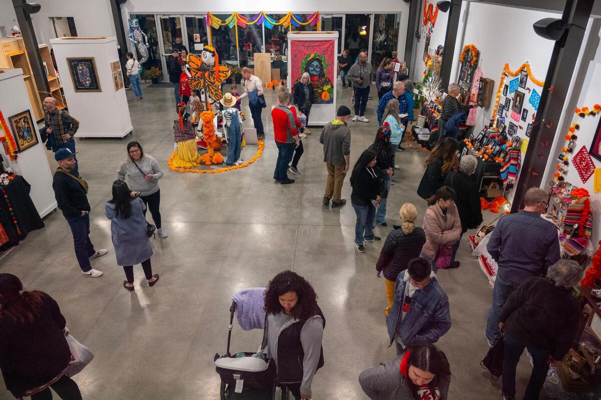 Visitors walk through the Mattie Rhodes Center to view ofrendas during the Dia de los Muertos festival on Friday, Nov. 3, 2023, in Kansas City.