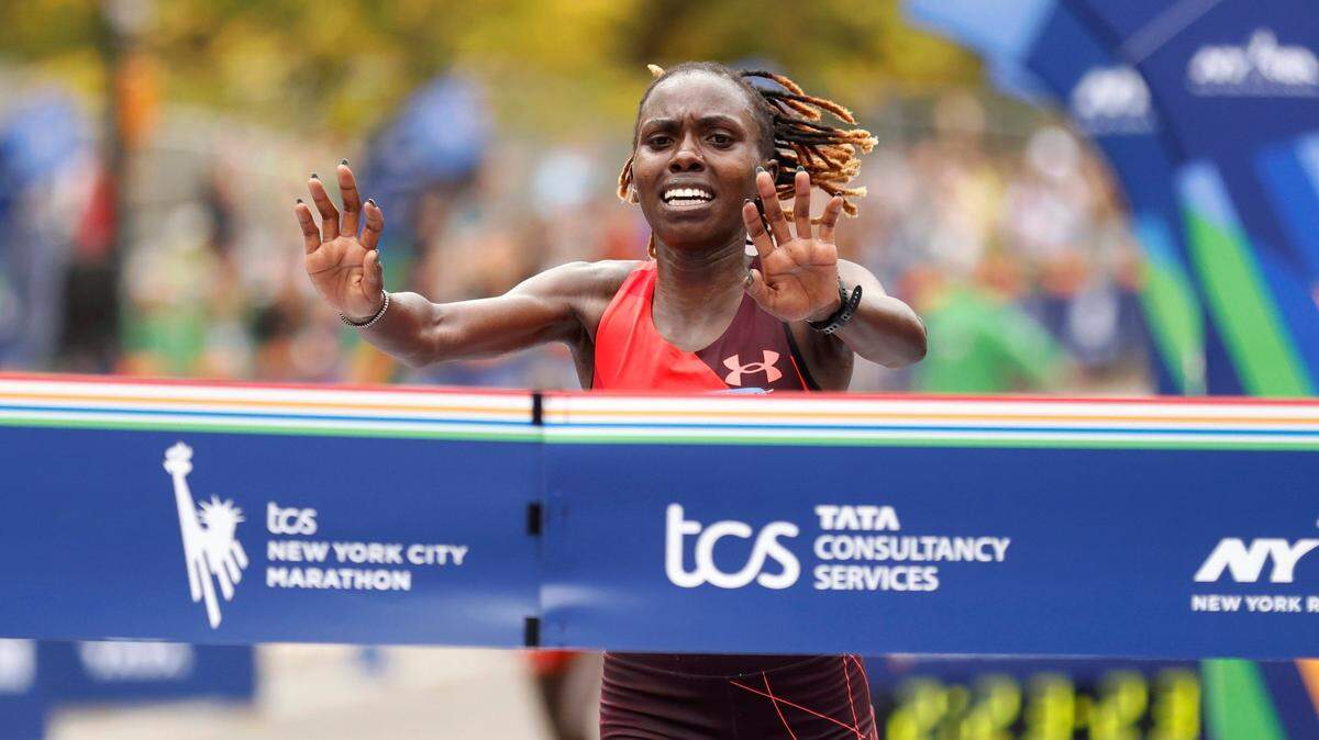 Sharon Lokedi, of Kenya and formerly a KU Jayhawks distance runner, crosses the finish line first in the women’s division of the New York City Marathon Sunday.