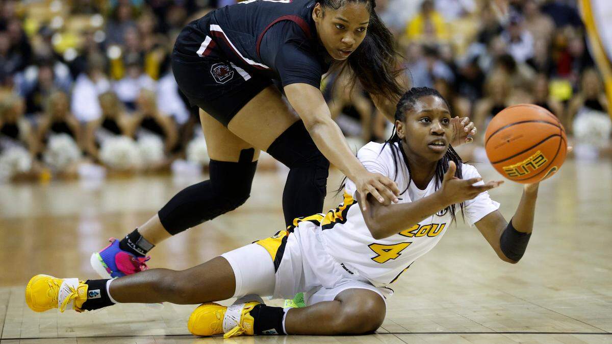 Missouri guard Mama Dembele looks to pass after gaining control of a loose ball as South Carolina guard Zia Cooke, left, defends during Thursday night’s game in Columbia, Mo.