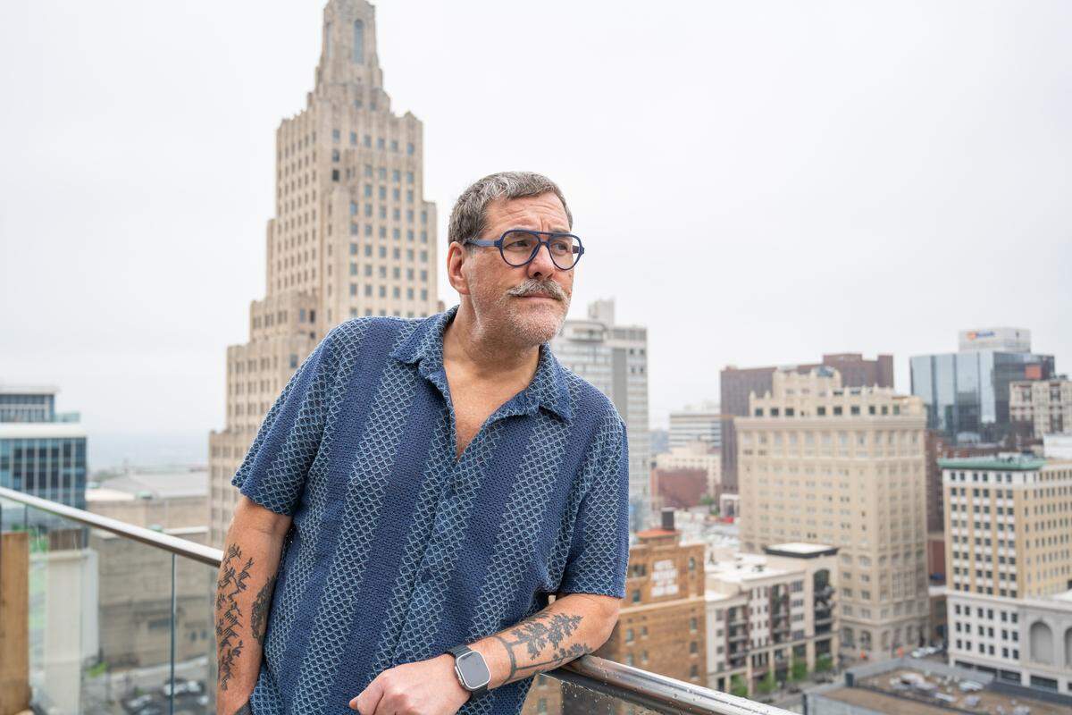Kris Saim outside his home on Friday, April 10, in Kansas City. Saim has Stage 4 terminal cancer and is recording a podcast, Dying Out Loud, that talks about death. Saim's aim is to provide an avenue for people that want to confront the reality of death.