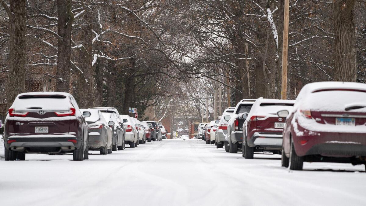 Parked cars line the snow-covered road along Holmes Street on Tuesday, Feb. 18, 2025, in Kansas City.