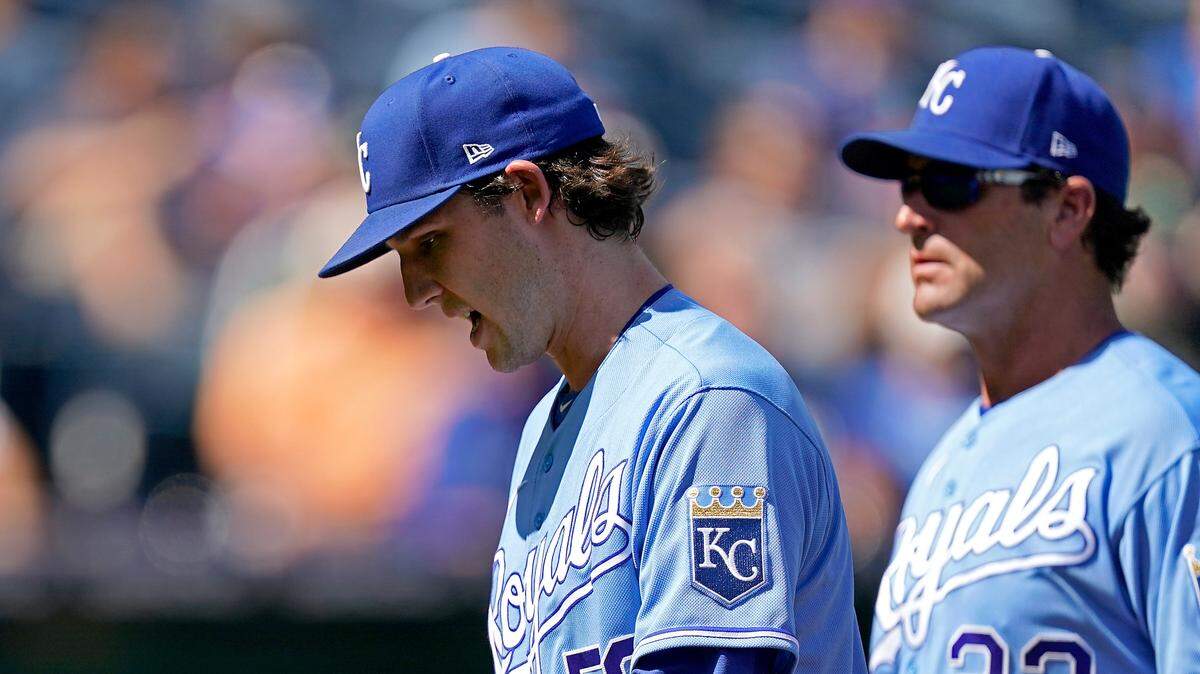 Kansas City Royals starting pitcher Daniel Lynch is followed to the dugout by Royals manager Mike Matheny as Lynch comes out of the game during the third inning on Thursday, Sept. 16, 2021, in Kansas City, Mo.