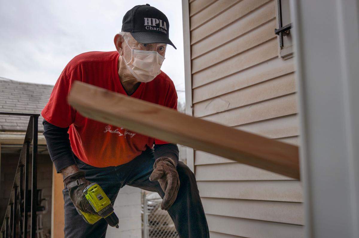 Robert Flores works on a deck repair for a resident on Dec. 17 in Kansas City, Kansas. Flores is chairman of Habitaciones Para Latinos Association, an organization that makes free home repairs for those in need in Wyandotte County.