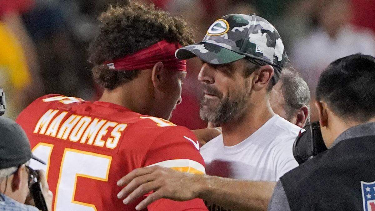 Kansas City Chiefs quarterback Patrick Mahomes (15) and Green Bay Packers quarterback Aaron Rodgers (12) embrace after a game at GEHA Field at Arrowhead Stadium.