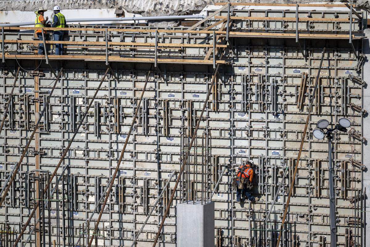 Construction crews worked on the new 30-foot tall west wall of the new parking garage at the Barney Allis Plaza Redevelopment Project on Wednesday, August 13, 2025, in Kansas City. The $118 million project is scheduled to be completed in the fourth quarter of 2026.