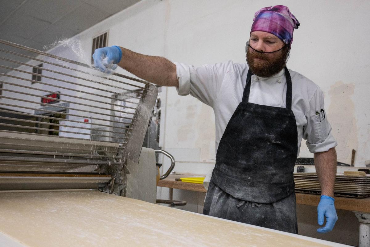Production manager Christian Engelage applies a dusting of flour onto pastry dough at Scratch KC.