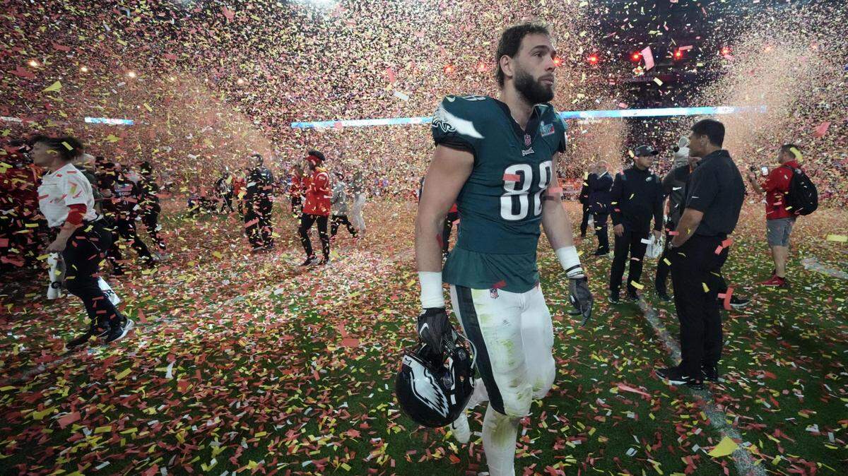 Philadelphia Eagles tight end Dallas Goedert (88) walks off the field as confetti falls after losing to the Kansas City Chiefs in Super Bowl LVII at State Farm Stadium in Glendale on Feb. 12, 2023.