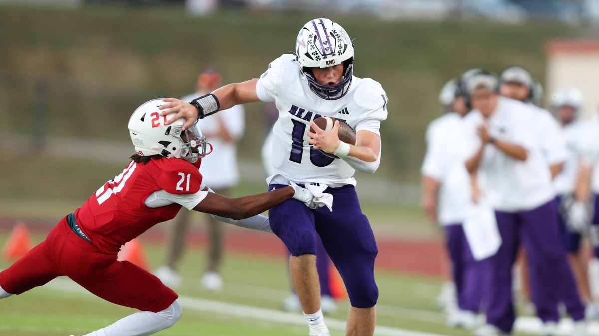 Kearney High School quarterback Temple Carter fends off a would-be tackler in a 14-7 football victory over Park Hill on Friday, Sept. 19, 2025.