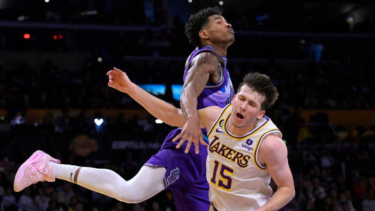 Apr 9, 2023; Los Angeles, California, USA; Los Angeles Lakers guard Austin Reaves (15) is fouled by Utah Jazz guard Ochai Agbaji (30) as he drives for a basket in the first half at Crypto.com Arena. Mandatory Credit: Jayne Kamin-Oncea-USA TODAY Sports