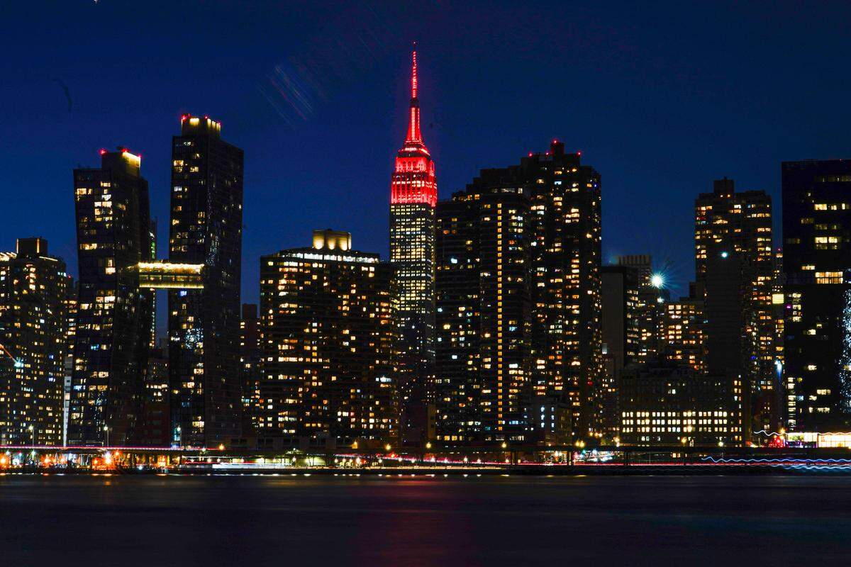 The Empire State Building is lit in “heartbeat” red as part of a national memorial to lives lost to COVID-19 Tuesday, Jan. 19, 2021, in New York. The U.S. death toll from the coronavirus has surpassed 400,000, providing a grim coda to Donald Trump’s presidency.