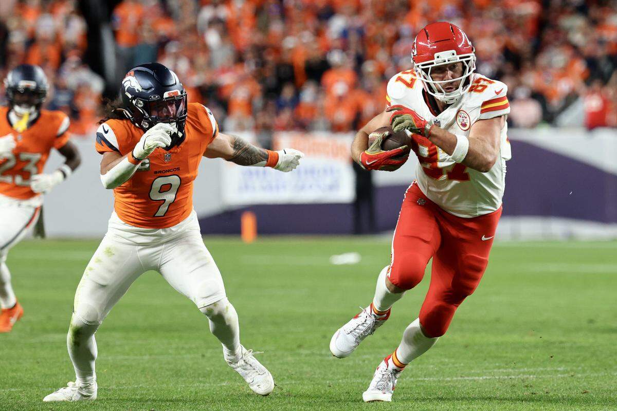 Kansas City Chiefs tight end Travis Kelce, right, runs after making a catch against the Broncos during an NFL Week 11 game at Empower Field At Mile High in Denver on Sunday, Nov. 16, 2025.
