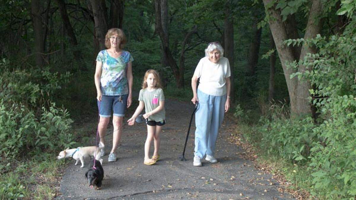 Mary Rye, Quinn McGeachy, and JoAnn VanKirk take a stroll in a neighborhood park.