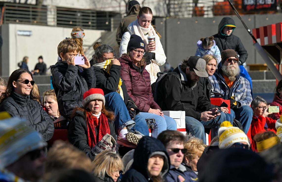 Visitors bundled up against the cold as they sat outside and watched the annual TubaChristmas holiday concert Tuesday in the Crown Center Square in Kansas City.