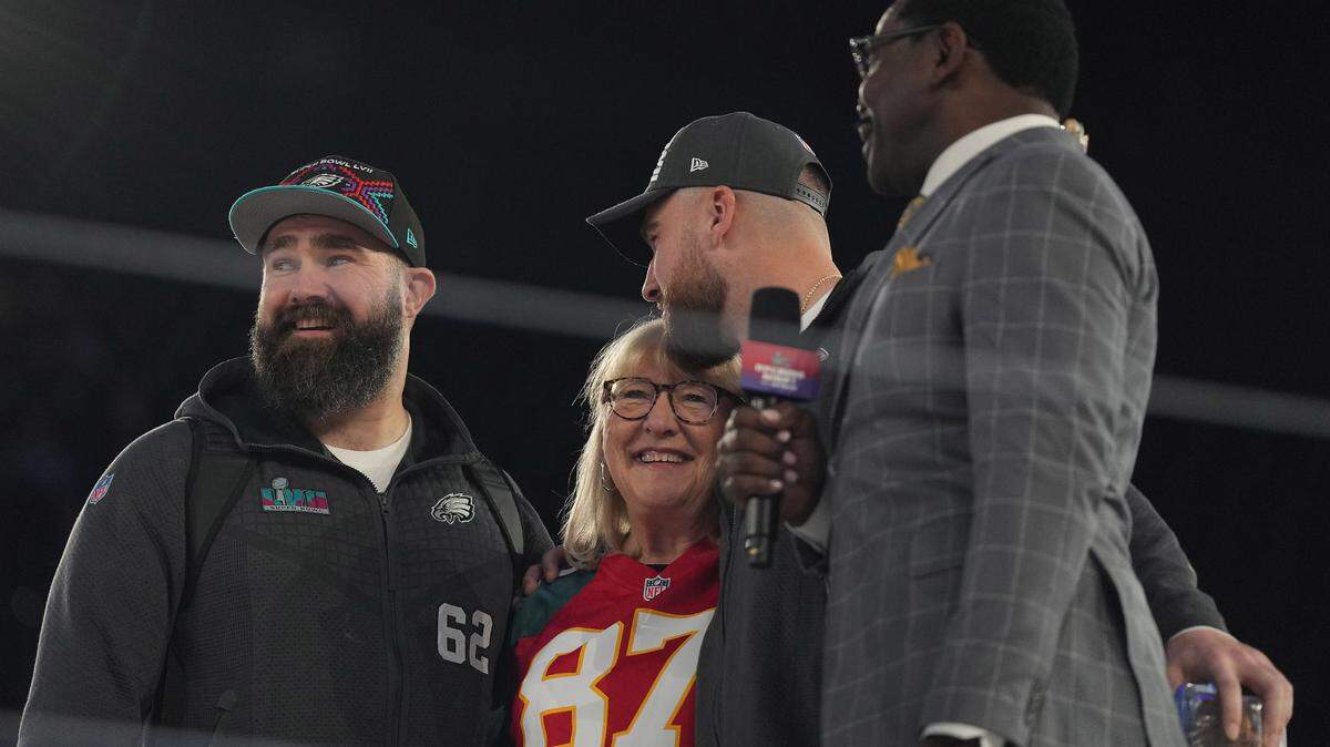 Feb 6, 2023; Phoenix, AZ, USA; Philadelphia Eagles center Jason Kelce (62) and Kansas City Chiefs tight end Travis Kelce (87) with their mother Donna Kelce are interviewed by NFL Network reporter Michael Irvin during Super Bowl Opening Night at Footprint Center. Mandatory Credit: Joe Camporeale-USA TODAY Sports
