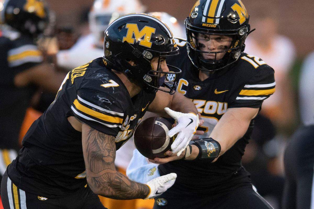 Missouri quarterback Brady Cook (12) hands the ball off to running back Cody Schrader (7) during their NCAA college football game against Tennessee on Saturday, November 11, 2023 in Columbia, MO.