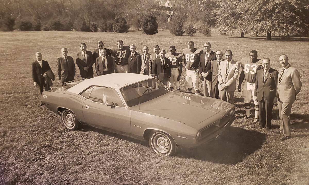 KC Chrysler/Plymouth dealers, Chiefs players and coaches pose with the car after practice in the fall of 1969.