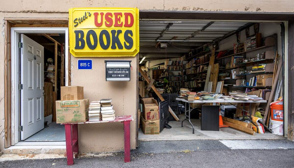 A bright yellow sign is displayed outside of Steel's Used Books at 8115 North Oak Suite C on Tuesday, June 23, 2026, in Kansas City.