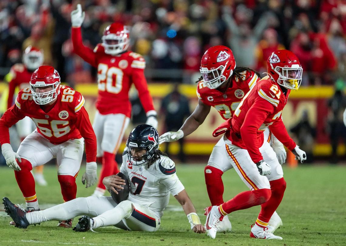 Kansas City Chiefs defensive end George Karlaftis (56) sacked Houston Texans quarterback C.J. Stroud (7) as Chiefs safety Jaden Hicks (21) Chiefs linebacker Nick Bolton (32) were in on the play in the second half of the AFC Divisional Round playoff game on Jan. 18, 2025, at GEHA Field at Arrowhead Stadium. The Chiefs defeated the Texans 23-14.