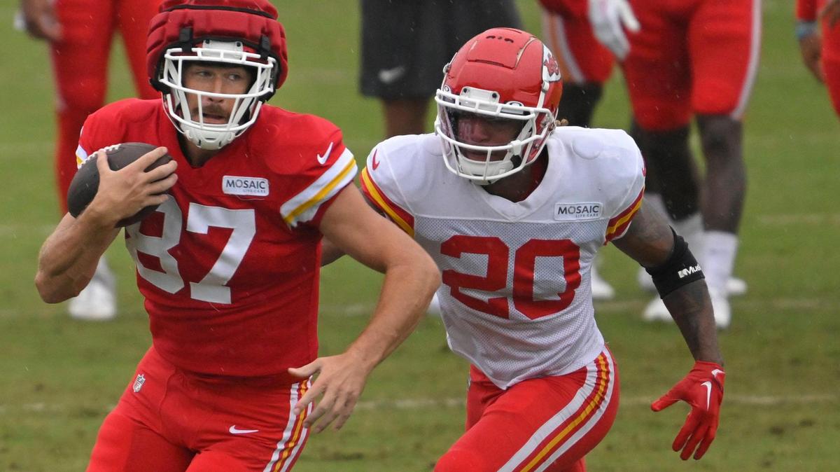 Chiefs tight end Travis Kelce (87) runs with the ball as safety Justin Reid (20) pursues during training camp at Missouri Western State University on Friday, Aug. 4, 2023, in St. Joseph, Missouri.
