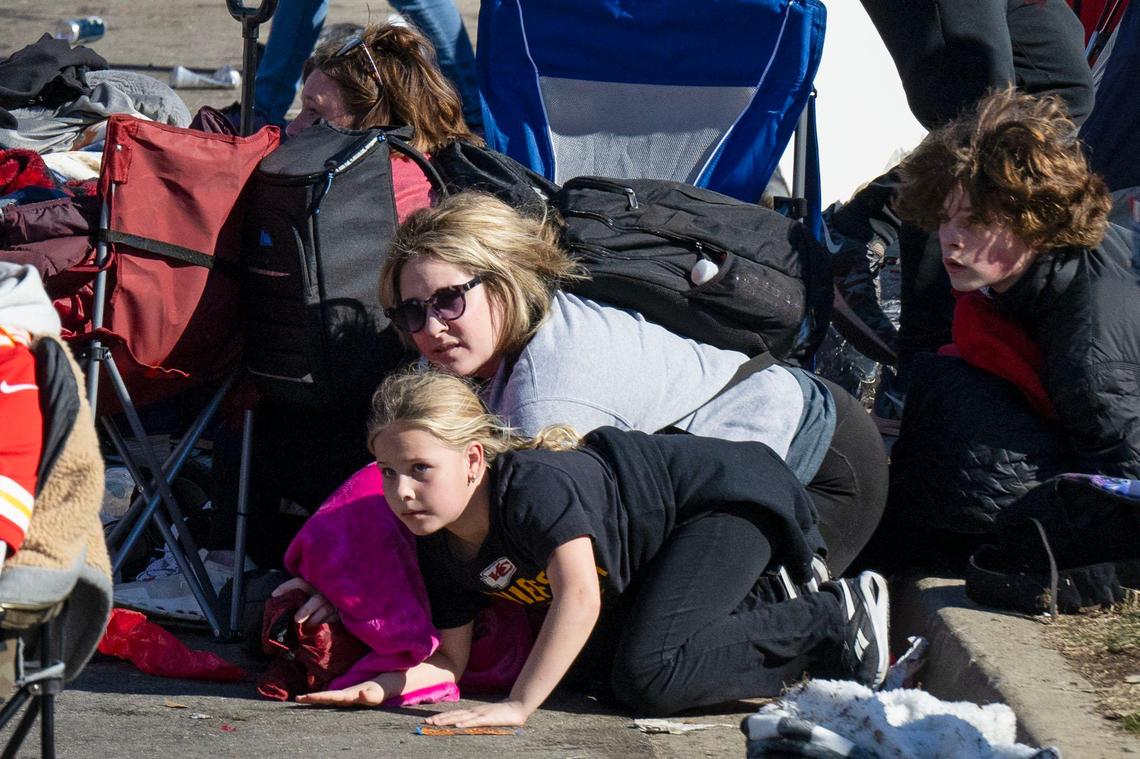 Kansas City Chiefs fans take cover after shots were fired during the Super Bowl Championship rally on Wednesday, Feb. 14, 2024, at Union Station in Kansas City. Twenty-two people were shot, including one fatally.