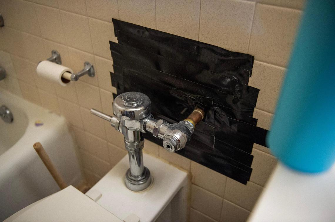 Duct tape covers a hole near the toilet plumbing in a studio apartment at Independence Towers on Tuesday, March 19, 2024, in Independence, Mo.