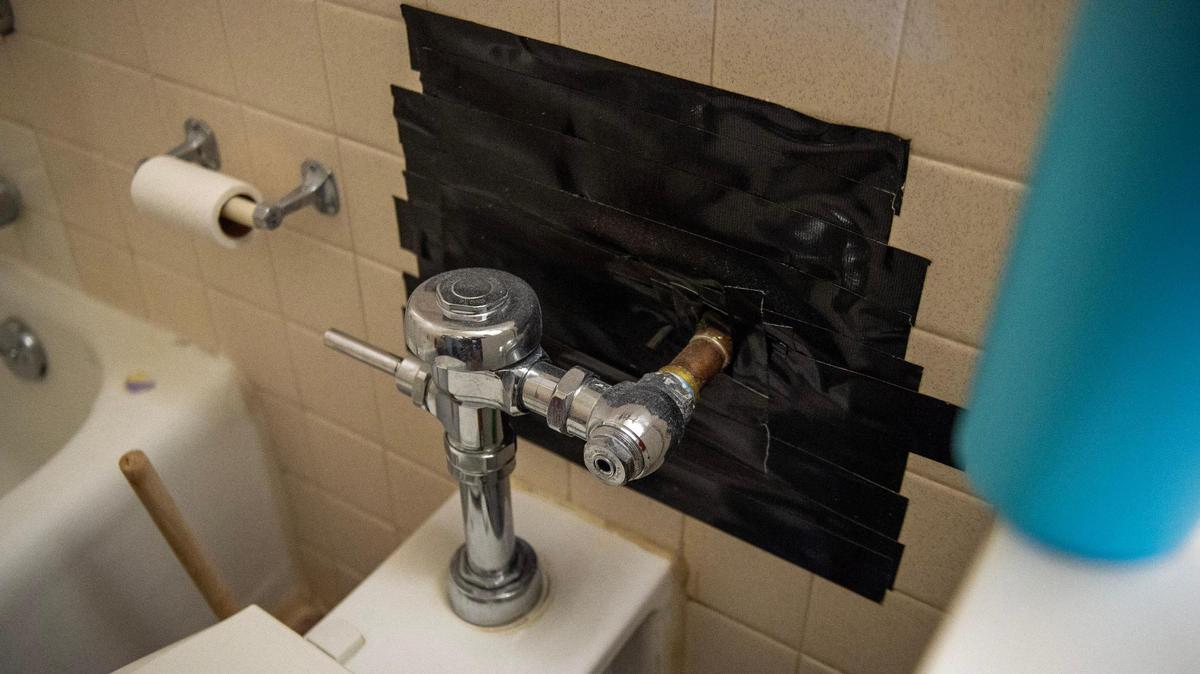 Duct tape covers a hole near the toilet plumbing in Michelle Paylor’s studio apartment at Independence Towers on March 19. Independence is one of the few municipalities in Jackson County to require health and safety inspections in rental units every two years.