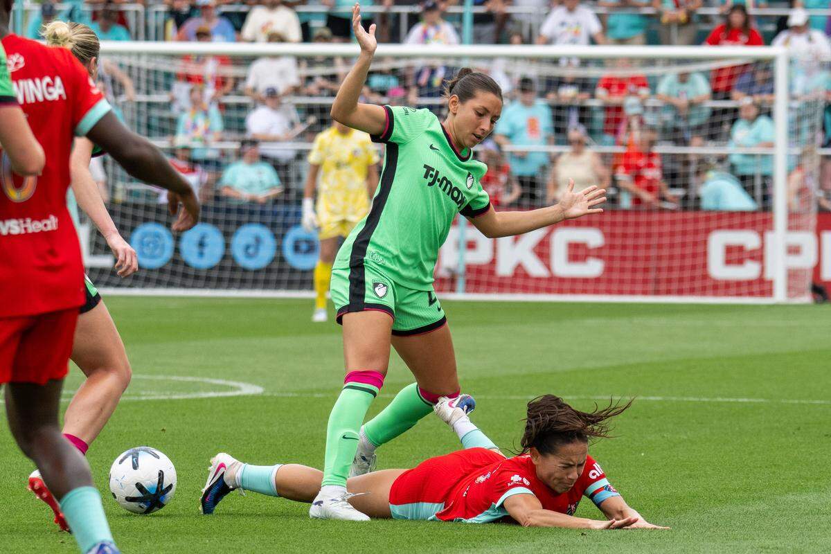 Current midfielder Lo'eau LaBonta (10) is knocked to the ground by a Boston Legacy FC player during KC’s 1-0 victory on Saturday, May 30, 2026 at CPKC Stadium in Kansas City.