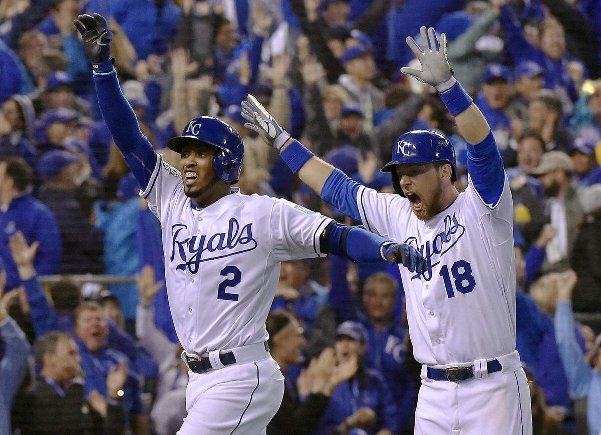 Kansas City Royals shortstop Alcides Escobar runs in while second baseman Ben Zobrist celebrated after Escobar hit an inside the park home run on the first pitch of the bottom of the first inning during Game 1 of the World Series on Tuesday, October 27, 2015 at Kauffman Stadium in Kansas City, Mo.