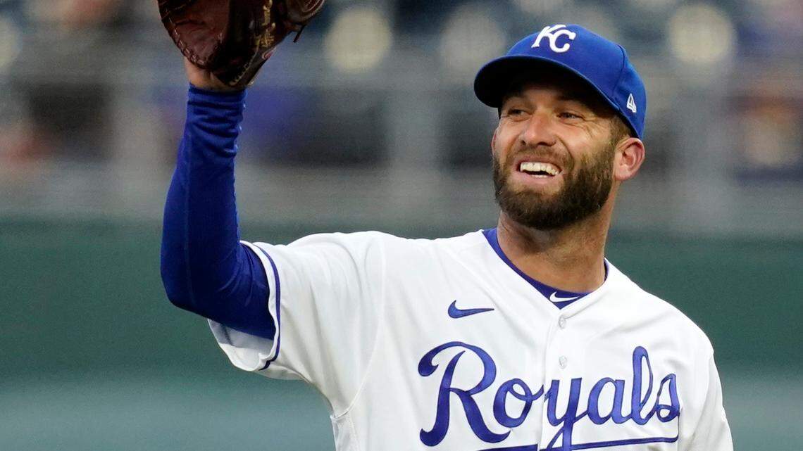 Kansas City Royals starting pitcher Danny Duffy receives the ball from third baseman Hunter Dozier after the first out of a baseball game against the Los Angeles Angels at Kauffman Stadium in Kansas City, Mo., Tuesday, April 13, 2021. (AP Photo/Orlin Wagner)