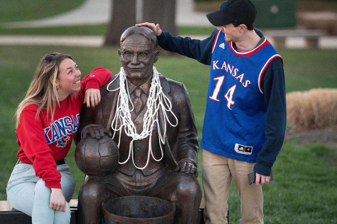 On their way to Allen Fieldhouse for a Kansas basketball watch party, two fans stopped for a quick minute at the statue of James Naismith, the inventor of basketball, outside the DeBruce Center, in April 2022.