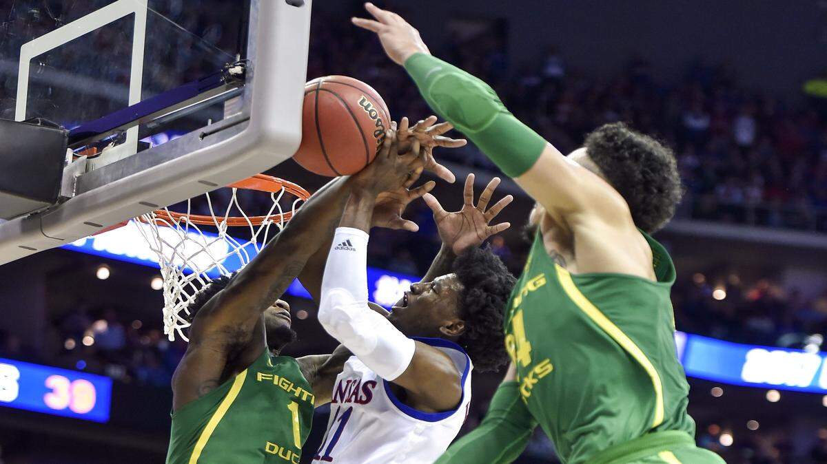Kansas guard Josh Jackson (11) has his shot blocked by Oregon Ducks forward Jordan Bell (1) in the second half of the Midwest Regional final of the NCAA Tournament at Sprint Center on Saturday, March 25, 2017, in Kansas City, Missouri.