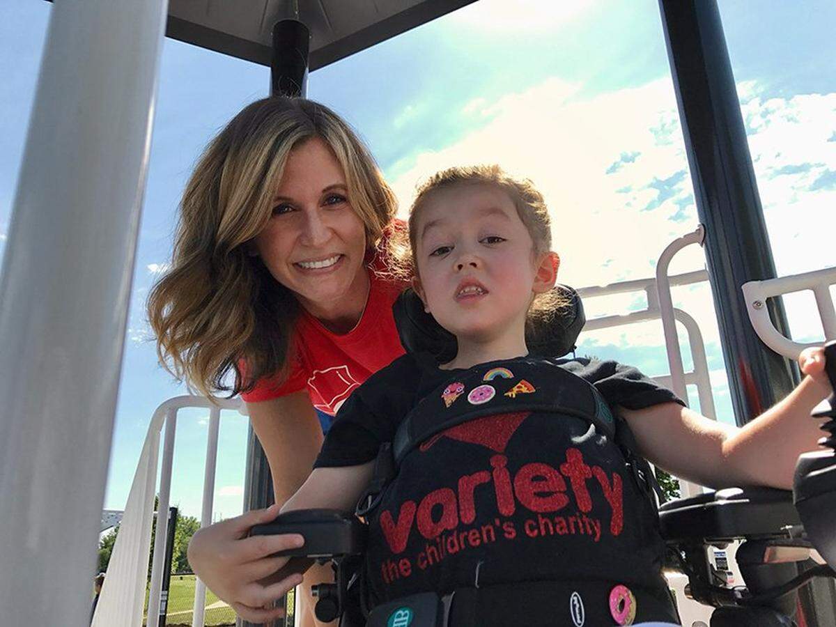 Sara Bloomfield with her daughter, Olivia Bloomfield, at the opening of the all-inclusive playground at Leawood City Park. It was the first playground Olivia, who was born with congenital muscular dystrophy and used a power wheelchair from 18 months old, fought to get in her city. She was a lifelong advocate for accessibility and inclusivity before she died on July 5, 2022, at the age of 10. 