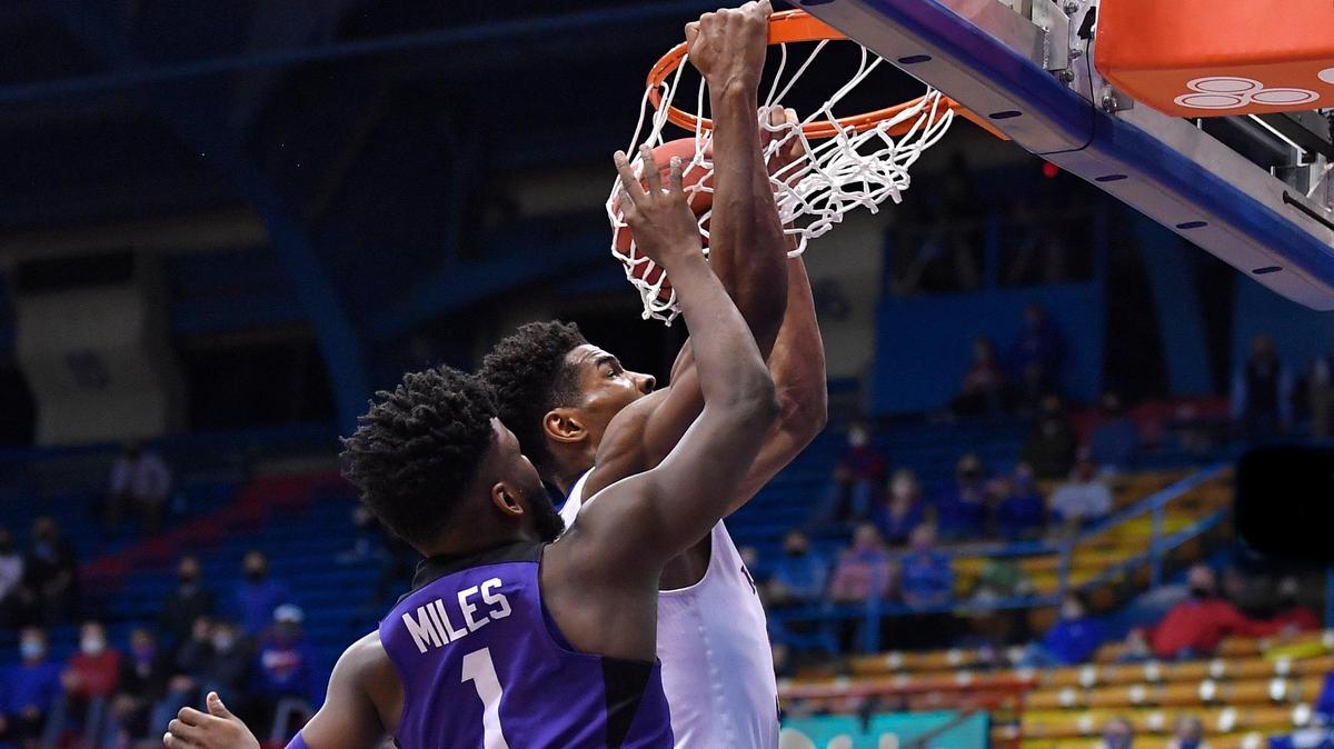 KU’s Ochai Agbaji dunks over TCU’s Mike Miles during the second half of Thursday night’s Big 12 Conference game at Allen Fieldhouse. KU beat TCU, 59-51.