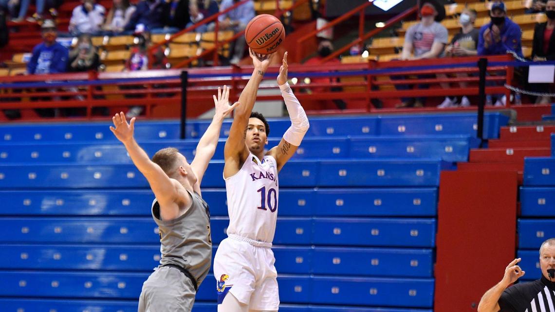 KU’s Jalen Wilson shoots over West Virginia’s Sean McNeil during the second half of Tuesday night’s Big 12 Conference game at Allen Fieldhouse.