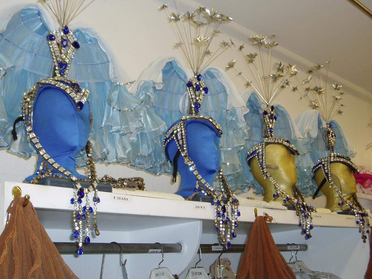 Headdresses for the “Jubilee!” show were not custom-made for individual showgirls. But one size didn’t fit all, either. Elastic and foam inserts kept them snug on various shaped heads.