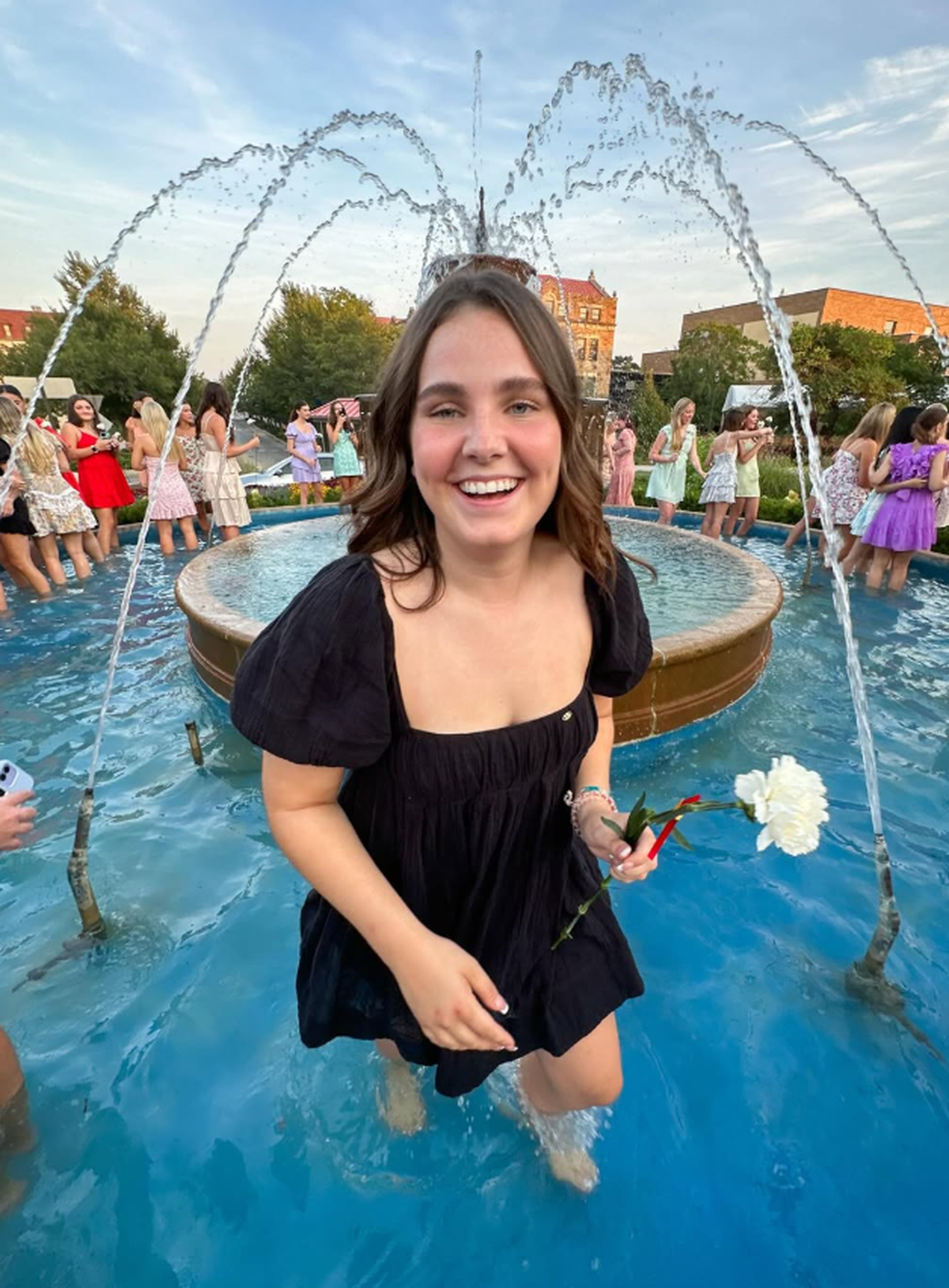 Elsa McGrain, seen here standing in the Chi Omega  water fountain. McGrain, a 20-year-old University of Kansas student set to graduate in 2026, was killed in a hit-and-run crash in Lawrence on Thursday, Nov. 6, while out jogging.