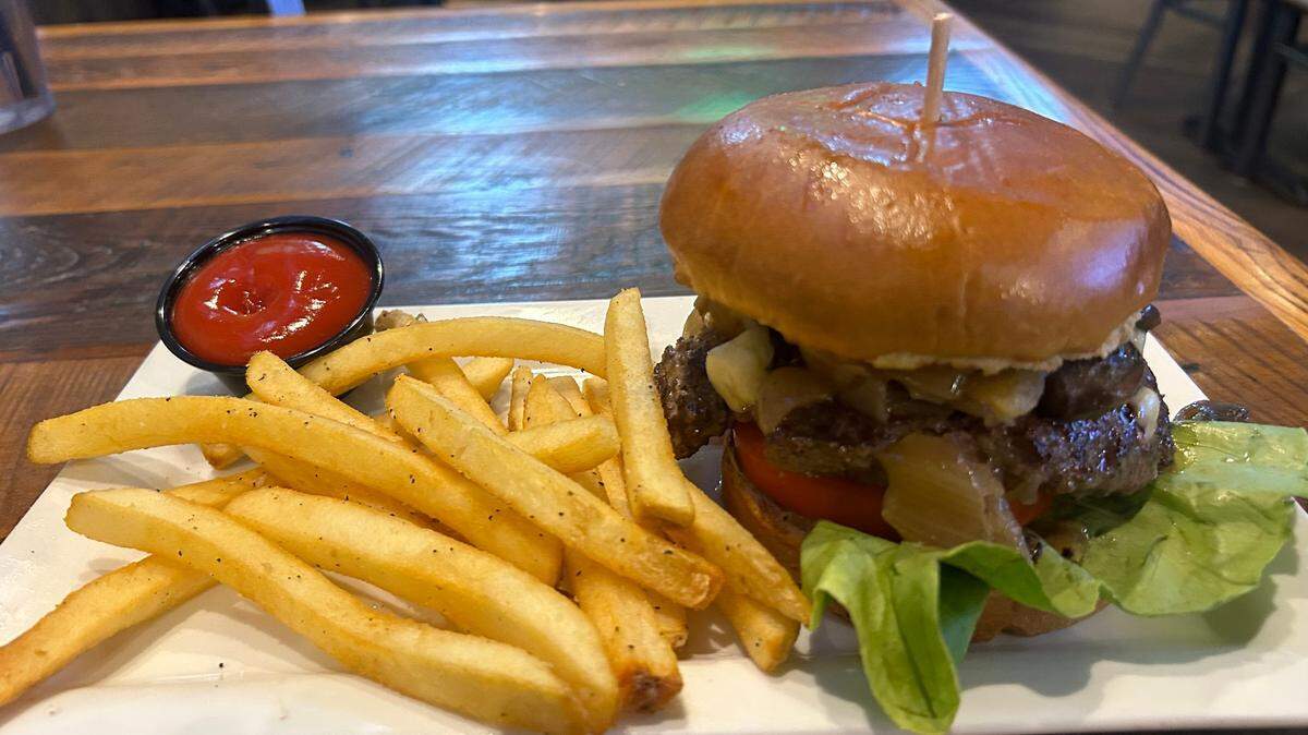 Burg & Barrel’s Bleu Moon burger has blue cheese crumbles, mushrooms, lettuce, tomatoes and pickles.
