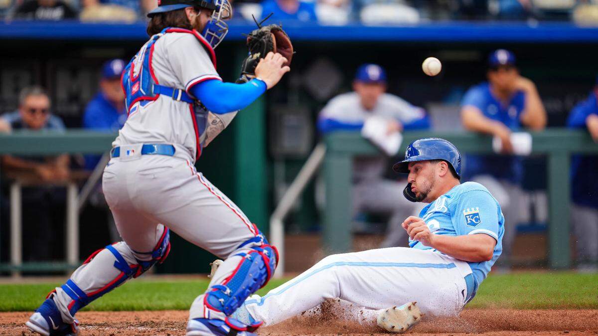 Royals first baseman Vinnie Pasquantino slides into home past Texas Rangers catcher Jonah Heim on Wednesday at Kauffman Stadium.