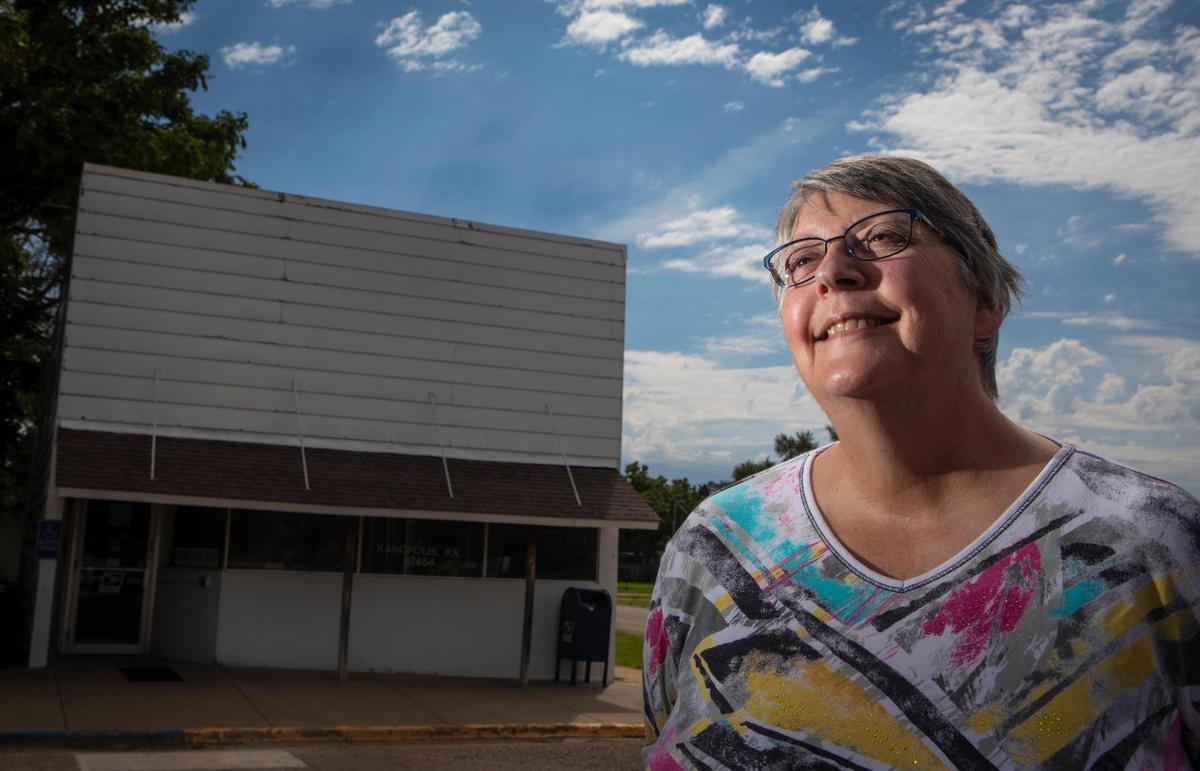 Peggy Hand, who retired in May after a 30-year career at the Ellsworth Post Office, stood outside the small post office in Kanopolis, Kansas, which is open for two hours a day.