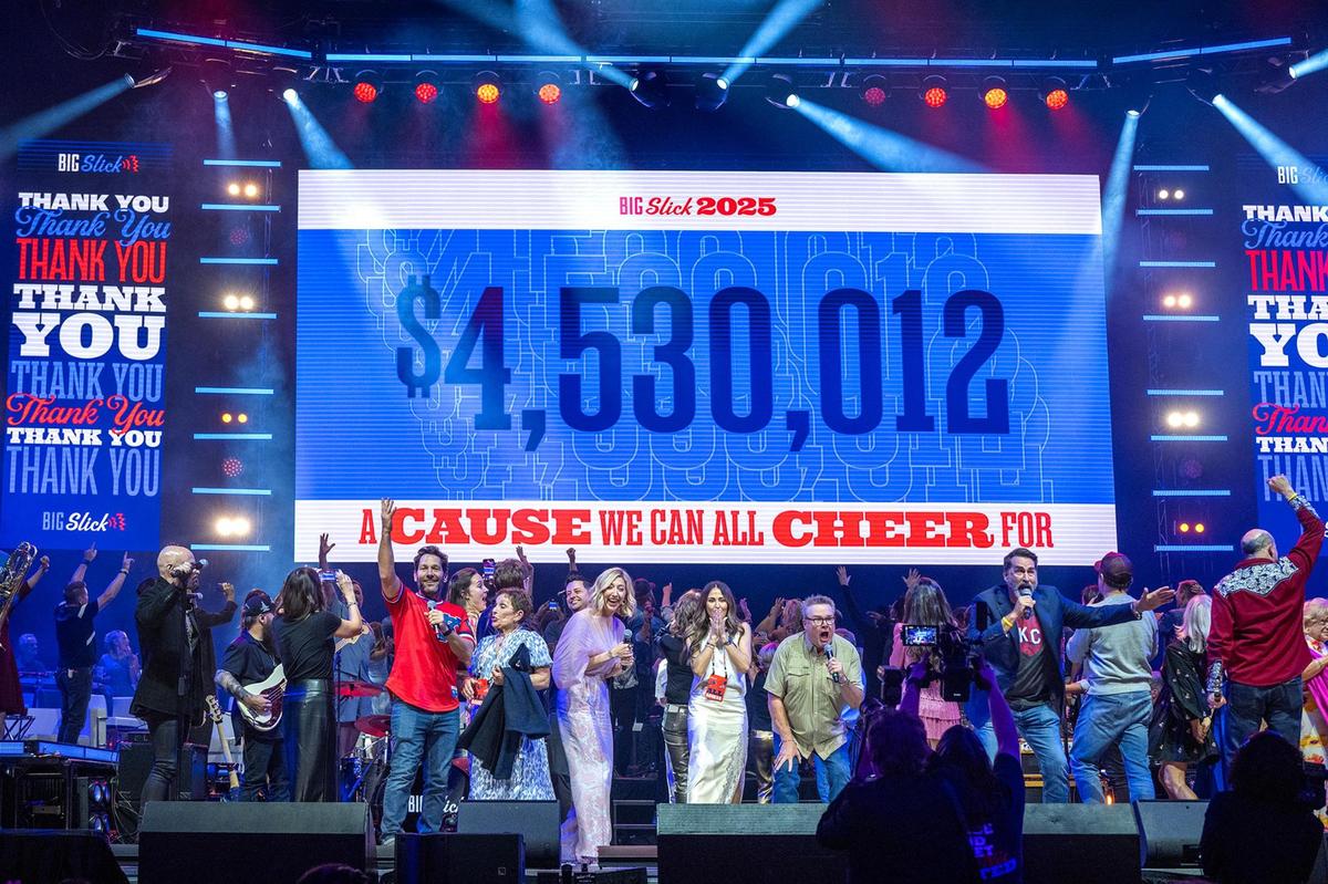 Hosts of the Big Slick Show including Paul Rudd, from left, Heidi Gardner, Eric Stonestreet, Rob Riggle and David Koechner on stage announcing they raised $4.5 million on the big screen on Saturday, May 31, 2025, at the T-Mobile Center in Kansas City. The proceeds benefit pediatric cancer at Children’s Mercy Hospital.