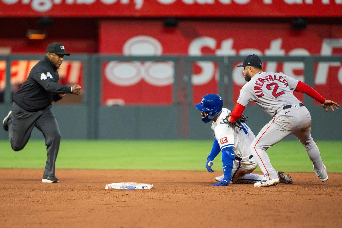 Kansas City Royals third baseman Maikel Garcia (11) is tagged out by Boston Red Sox second baseman Isiah Kiner-Falefa (2) in the Royals’ loss on Tuesday, May 19, 2026, at Kauffman Stadium.