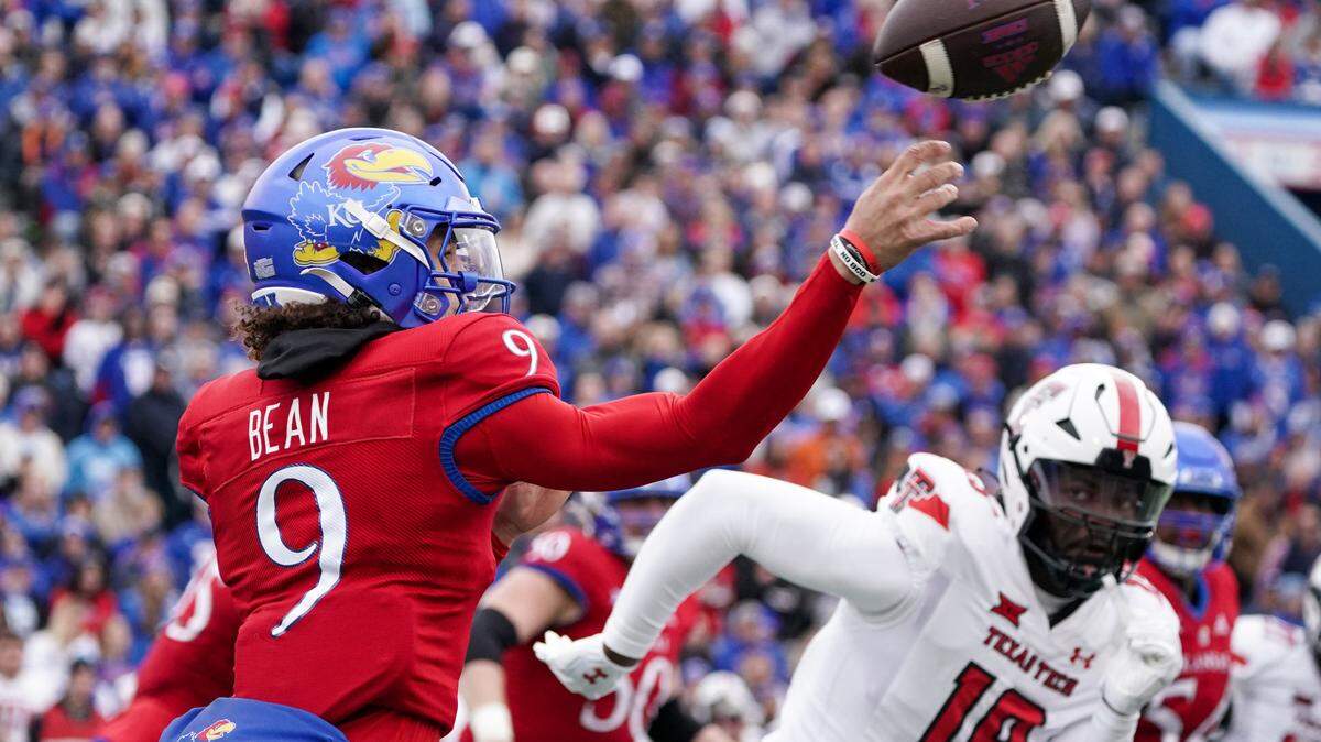 Kansas Jayhawks quarterback Jason Bean passes the ball against the Red Raiders during Saturday’s game at David Booth Kansas Memorial Stadium.