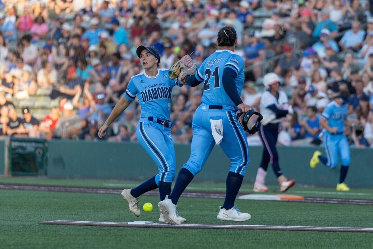 KC Diamonds infielder Allie Skaggs, left, high-fives pitcher Hope Valdespino during the pro softball team’s home opener at Legends Field in Kansas City, Kansas on Wednesday, June 17, 2026. The KC Diamonds beat the Florida Vibes 5-3.