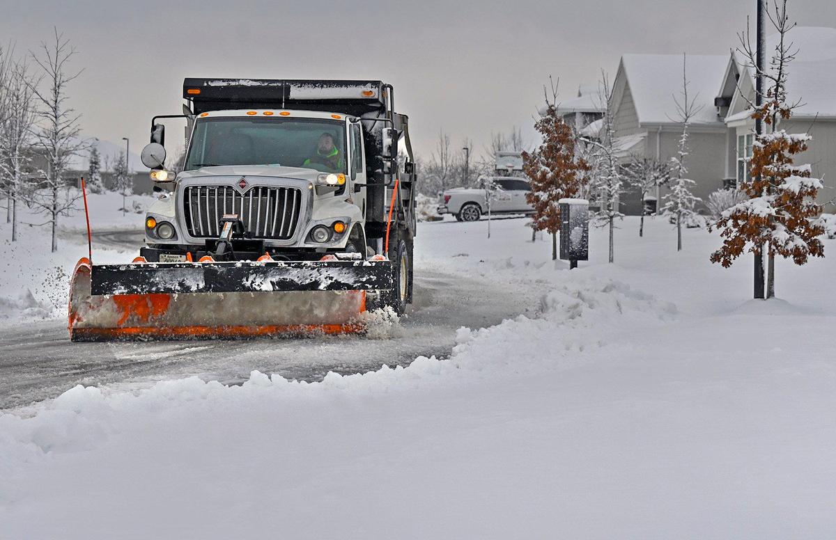 A snow plow clears West 96th Street in western Lenexa on Tuesday, Jan. 9, 2024, after an overnight winter storm dumped several inches of snow in the Kansas City area.