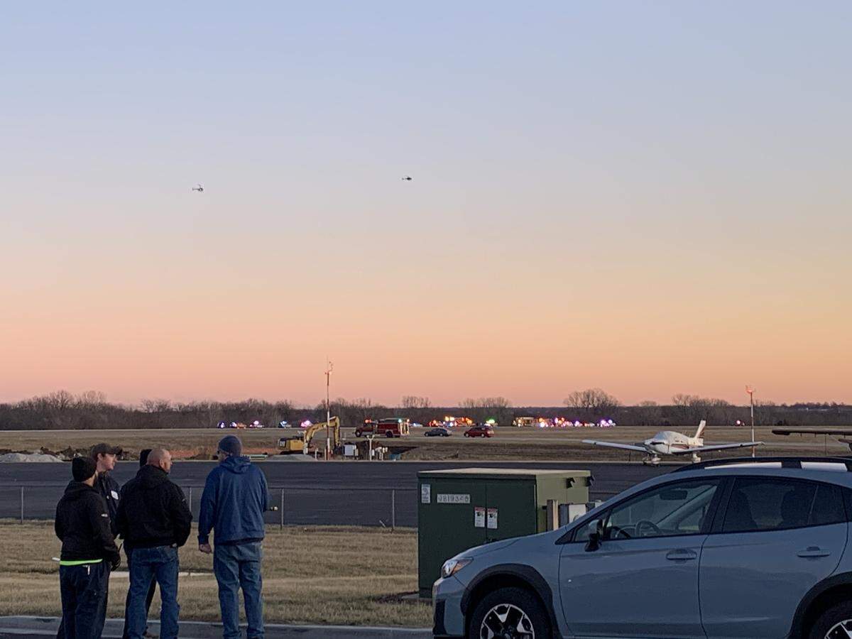 Police and emergency vehicles were on the scene of a crash adjacent to the Johnson County Executive Airport. Two in a small aircraft died in the accident.