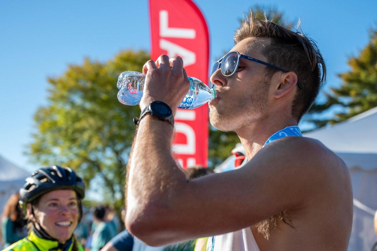 Jason Fambrough, Saturday’s overall men’s winner, takes a sip of water after completing the 2023 Garmin Kansas City Marathon.