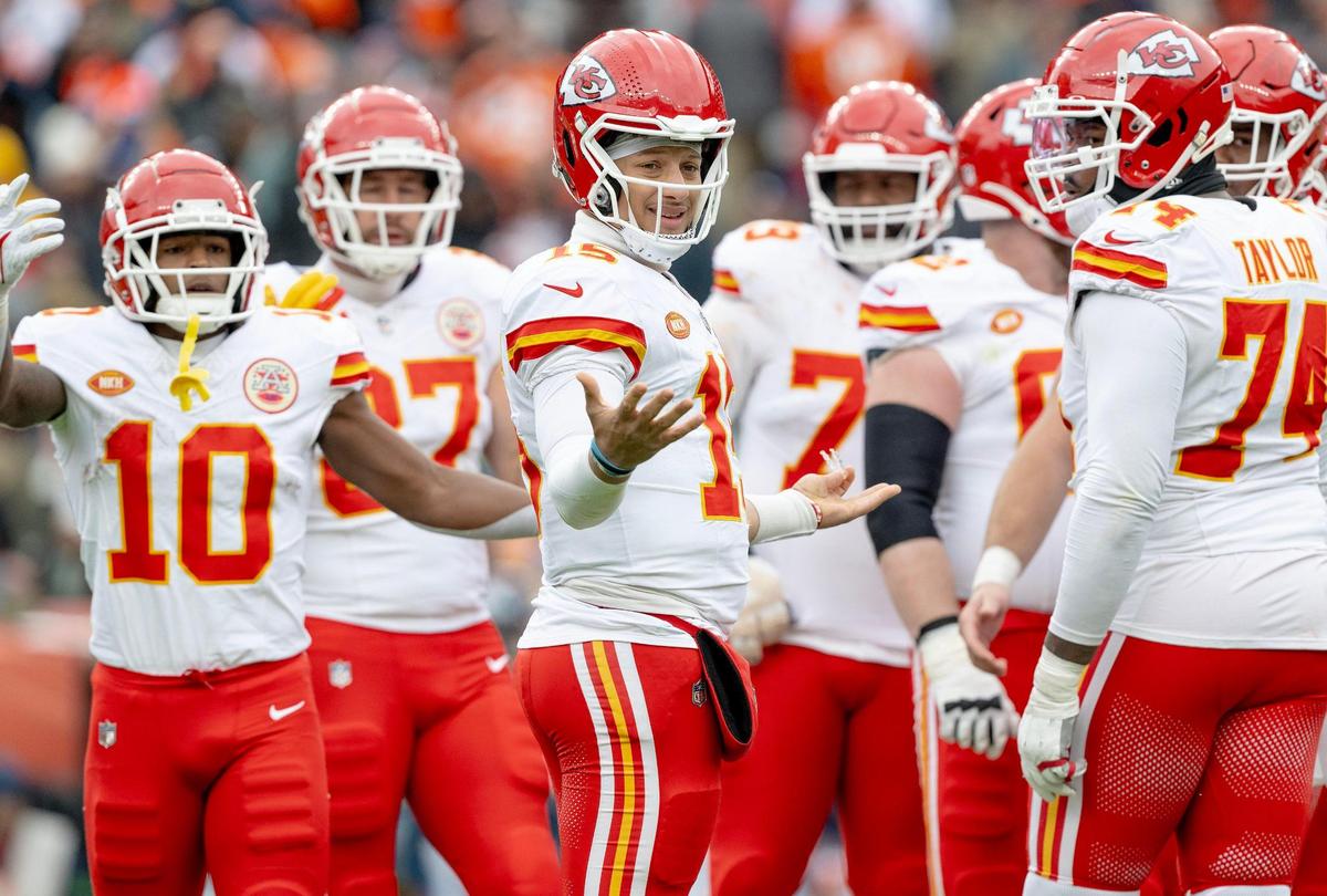 Chiefs quarterback Patrick Mahomes (at center of photo) looks to the sideline during a late-October game at Denver.